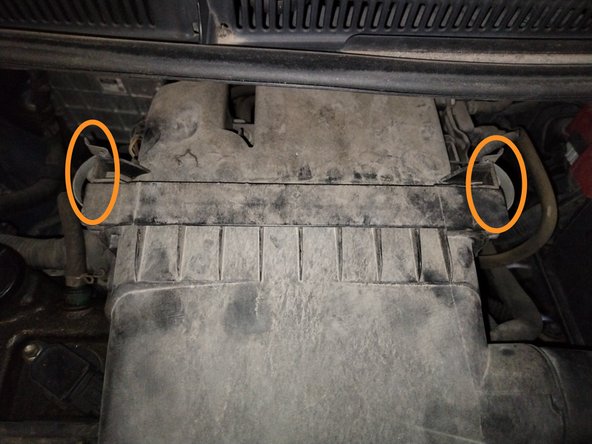 
The box is held in place by two metal clips. Flip them outwards.
