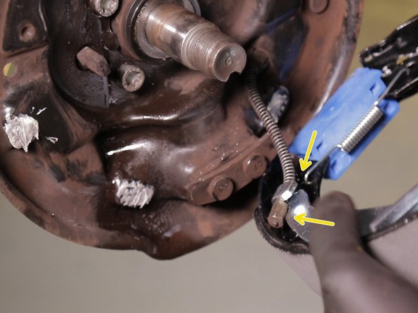 Replacer le câble de frein à main dans le crochet sur les mâchoires