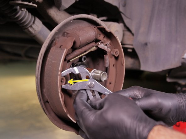 A l'aide de la pince multiprise, retirer la tête du rivet en appuyant sur le ressort et le faire pivoter