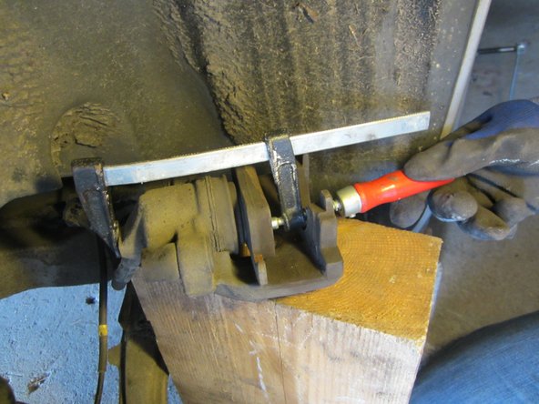 A l'aide d'un petit serre-joint ici mais utiliser plutôt un repousse piston , repousser le piston en s'appuyant sur l'ancienne plaquette.