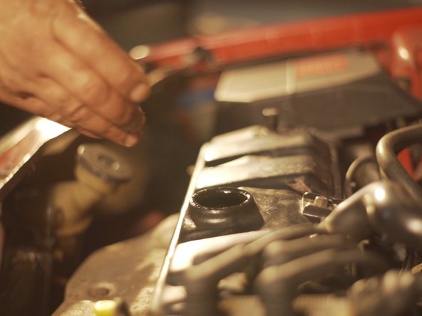 
Remove the engine oil filler cap
