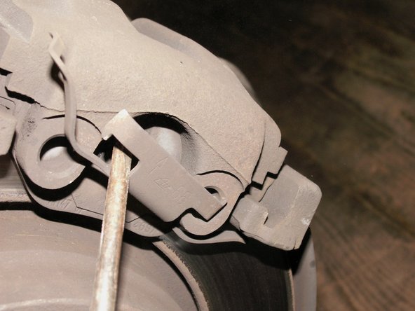 Retirer le ressort en faisant levier avec un tournevis plat.