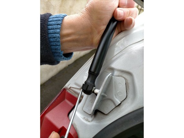 Mettre en place le vérin côté hayon en levant un peu l'agrafe avec un tournevis plat.