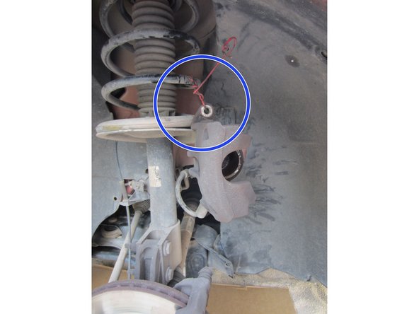 Suspendre l’étrier avec un fil de fer sur le ressort d'amortisseur