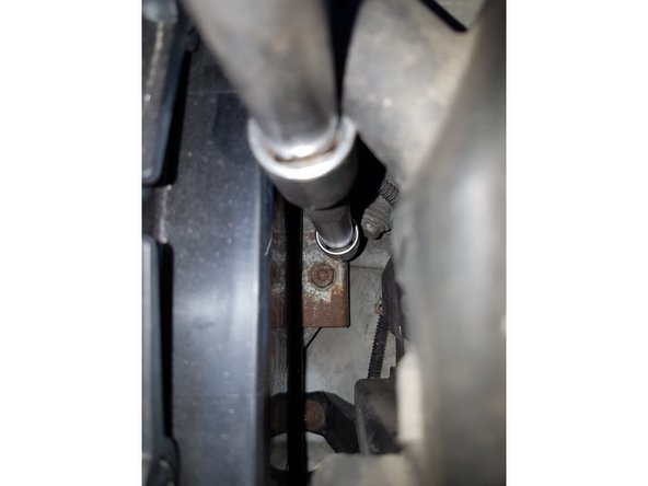 Et on dévisse le support de batterie qui se trouve en bas à droite de la batterie (douille de 13 avec rallonge)