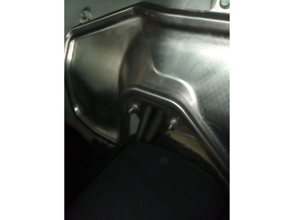 Reposer la trappe moteur et la fixer avec les 7 vis et 2 écrous à l'aide de la clé de 10 mm.