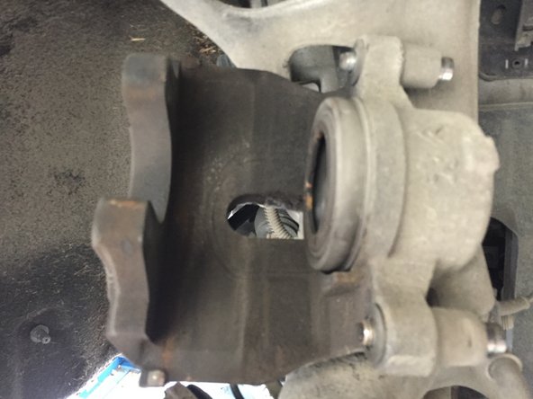 
Using a pair of pliers, push the piston back
