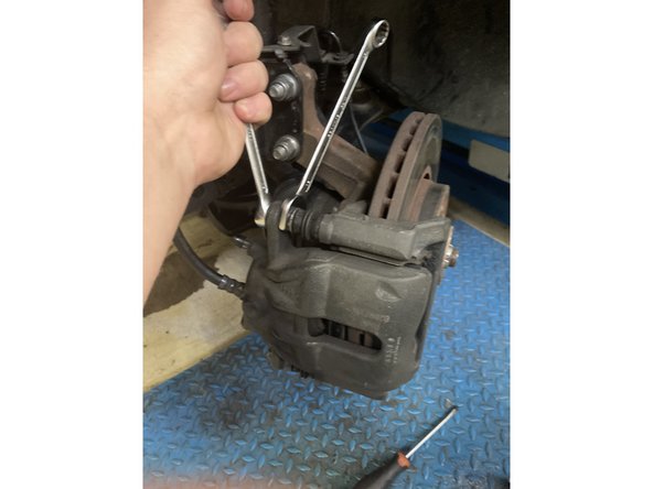 devise l’étrier à laine de 2 clé Plate une de 13 est l’autre de 15 et deviser le flexible de liquide de frein à l’aide d’une clé plate de 14