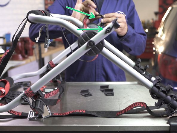 Une fois les 2 première sangles assemblées, faites-les passer dans les crochets se trouvant des deux côtés du porte vélos. Une sangle par crochet