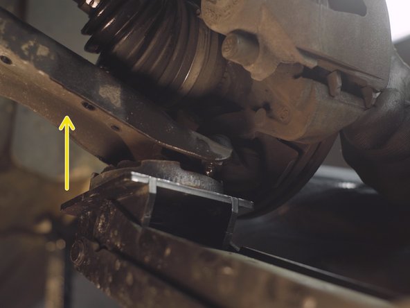 A l'aide du cric placé, monter légèrement la fusée pour enfoncer l'amortisseur