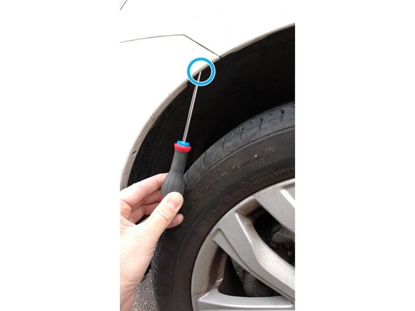 
Using the Phillips screwdriver, unscrew the screw located on the edge inside the front wheel arch.

