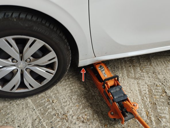 serrer le frein à main et lever la roue avant gauche