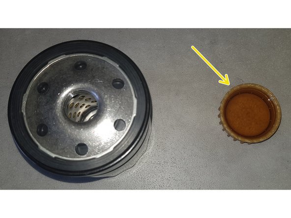 Remplissez le bouchon du bidon d'huile avec de l'huile neuve.