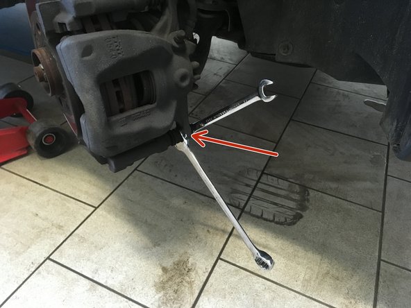 Déviser la vis du bas de l'étrier à l'aide de la clé de 13 et 18