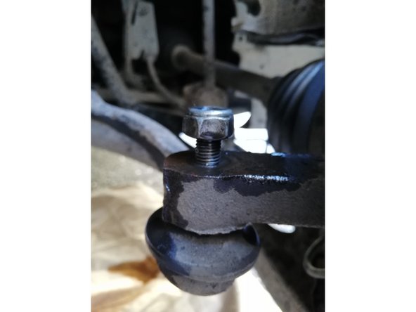 
The ball joint may not come out of its housing, as shown in the picture. Help it out by tapping it lightly, but do not tap directly on the thread if you want to reuse the steering ball joint.
