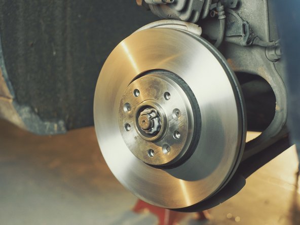 Appliquer du nettoyant frein et frotter avec un chiffon pour retirer la couche de paraffine présente sur le disque