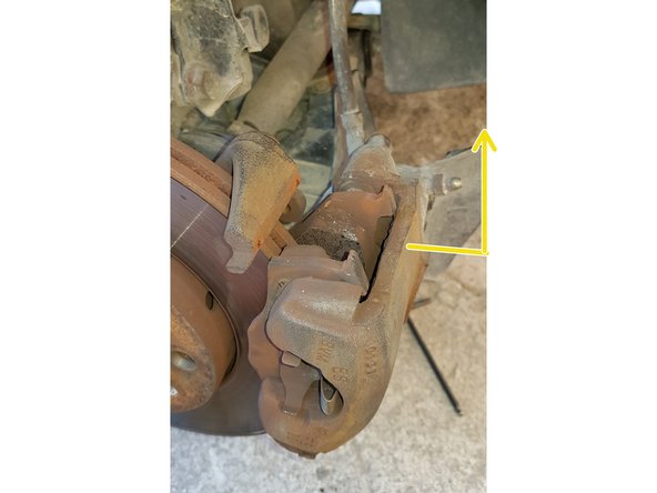 Tirez la partie supérieure de l'étrier vers l'extérieur puis vers le haut.