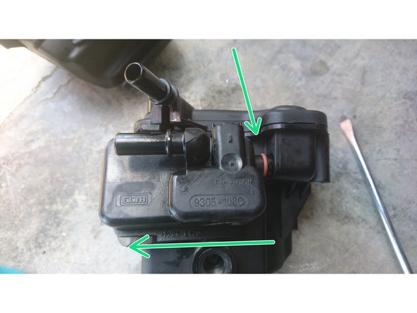 Il faut désaccoupler la partie amovible du filtre. On peu s'aider d'un tournevis plat pour faire levier au niveau de la flèche du haut.