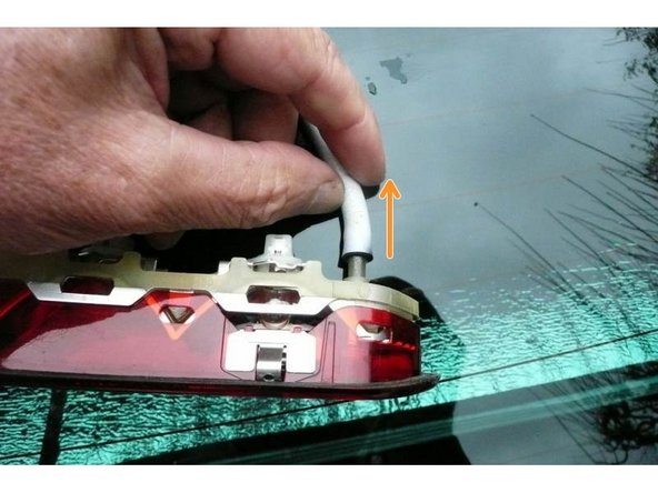 Déconnecter le tuyau de lave-glace et déposer le feu.