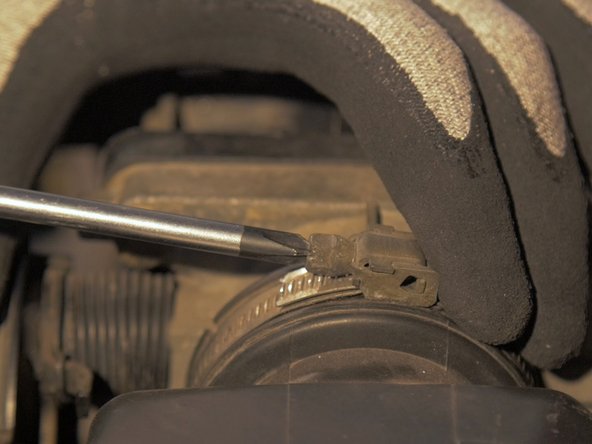 
Loosen the clamp screw on the throttle body with a flat screwdriver
