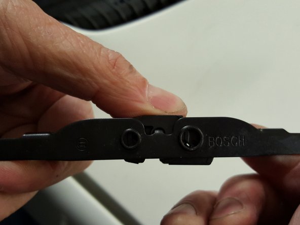 
Reattach the plastic clip to the new wipers. Simply press it to clip it in place.
