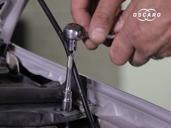 Dévisser la vis  a droite de la traverse en plastique à l'aide du cliquet et de la douille de 10