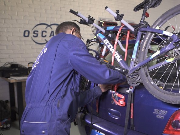 Placer la sangle rouge de manière à pouvoir maintenir le(s) vélo(s)