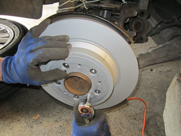 Remonter le nouveau disque, revisser la vis avec la douille de 10mm. Vérifier en vissant les goujons de roue que les trous soient alignés.