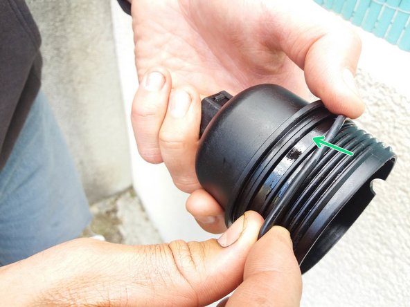 Placer le nouveau joint (fourni avec le filtre) dans la gorge (flèche verte) et non au bout du filetage.