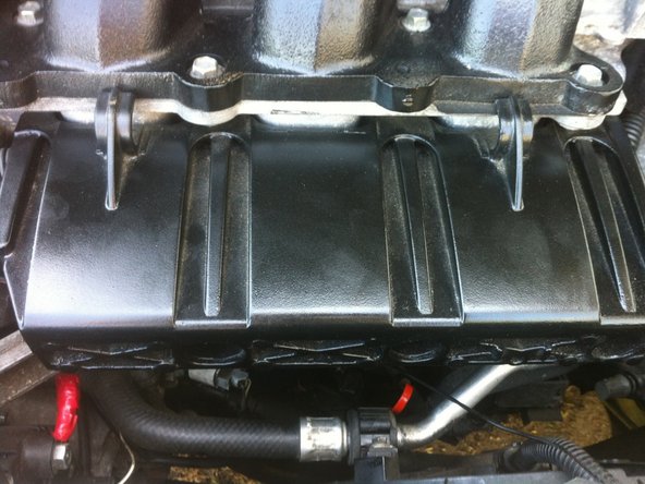 
Put the injector protection shim back in place. To do this, simply do the reverse of the disassembly. Just be careful not to pinch any wires when putting the shim back in place.
