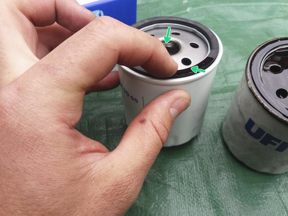 
Apply a drizzle of new oil to the gasket of the new oil filter and to the threads in the center.
