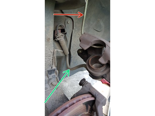 Accrochez l'étrier sur le ressort.