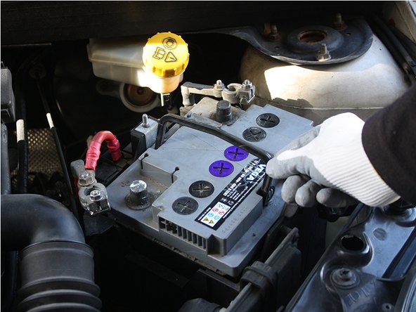 Lever la poignée de la batterie.