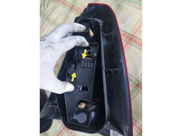 
pinch the two retaining tabs
