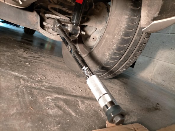 Remettre la voiture sur ses roues avant de serrer la vis de la fixation basse à la clé dynamométrique à 7,4 daNm.