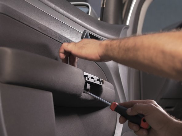 Dévisser les 2 vis se trouvant derrière la poignée à l'aide d'un tournevis Torx 30