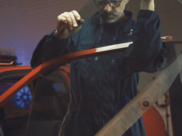 
Remove the window from the top by passing it through the outside of the door
