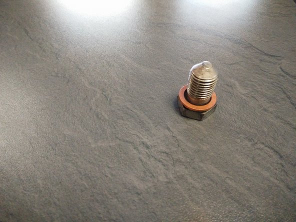 derrière le moteur i y a une vis de 19 qu'il faut enlever, il faut impérativement mettre un récipient de 5 litre afin de récupérer l'huile usagé et enfin remettre la vis de 19 avec un joint neuf et remettre le cache sous moteur.