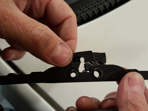 
Reattach the plastic clip to the new wipers. Simply press it to clip it in place.
