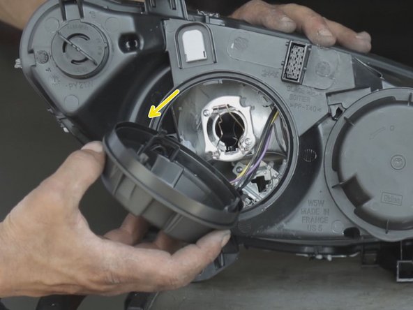 Dévisser et retirer les deux caches placés derrière le phare (réaliser cette opération sur l'ancien et le nouveau phare afin de récupérer les ampoules)