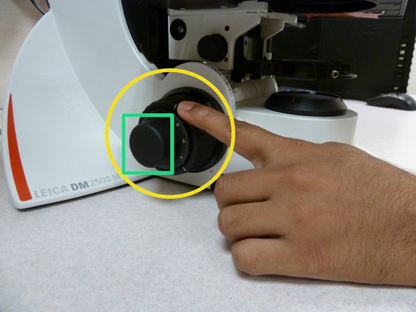 The knob with a bigger diameter is generally referred to as the 'coarse' knob.