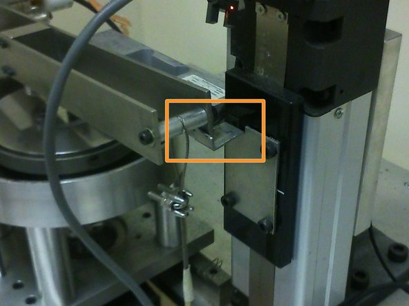 Place the end of the cantilever beam on the edge of the actuator's arm.