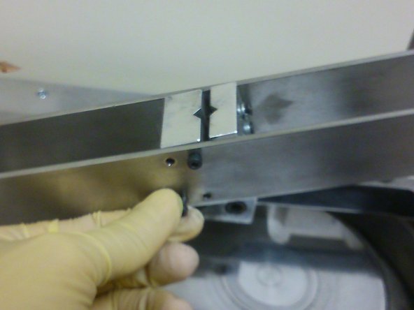 Use an allen key to hand-tighten four M3 screws on the side of the cantilever beam facing the user.