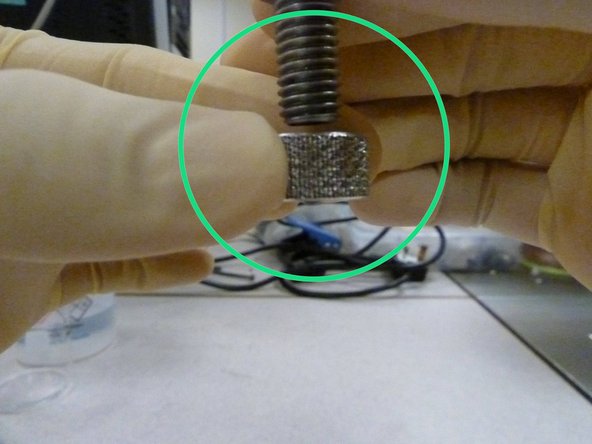 Unscrew the M12 bolt slowly, keeping the exposed surface in the same position as before