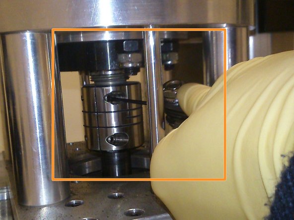 Using an allen key, hand-tighten the loose screw.