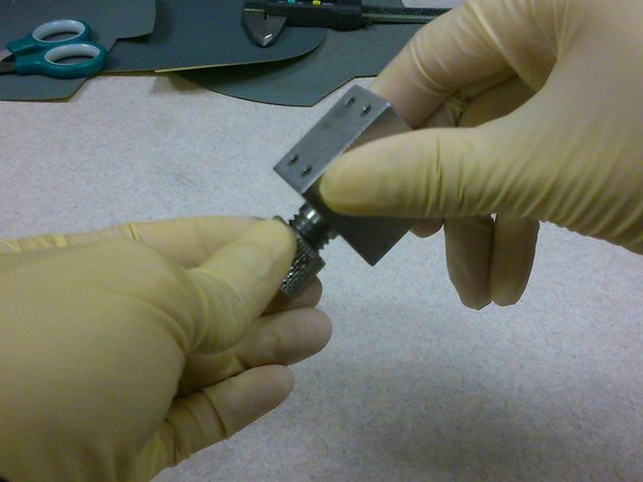 Keeping the smooth surface exposed, carefully screw the sample holder together.