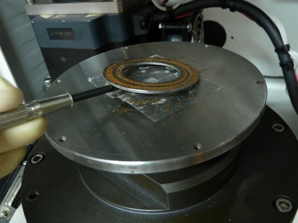 A screw driver acts as a lever at and helps remove the disc from the wear tester easily