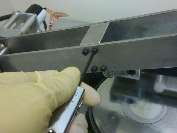 Use an allen key to hand-tighten four M3 screws on the side of the cantilever beam facing the user.