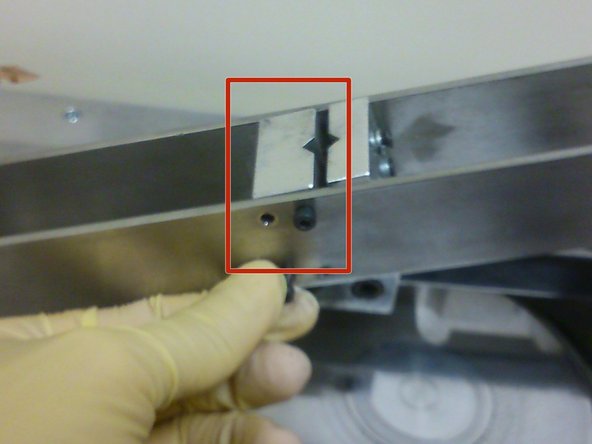 Using an allen key, secure the sample holder onto the cantilever beam using four M3 screws on the side of the cantilever beam facing the user.