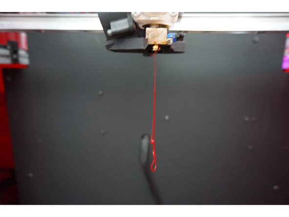 Once your filament starts coming out of the hotend,  clean off the filament if it's still hanging from the hotend.